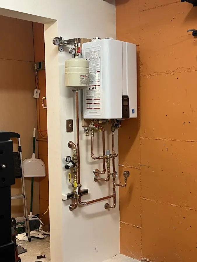 Plumbing technician inspecting water heater connections in Springboro
